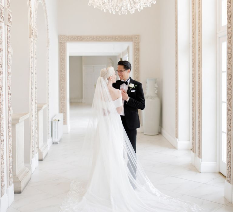 Bride in Mori Lee wedding dress and cathedral length veil