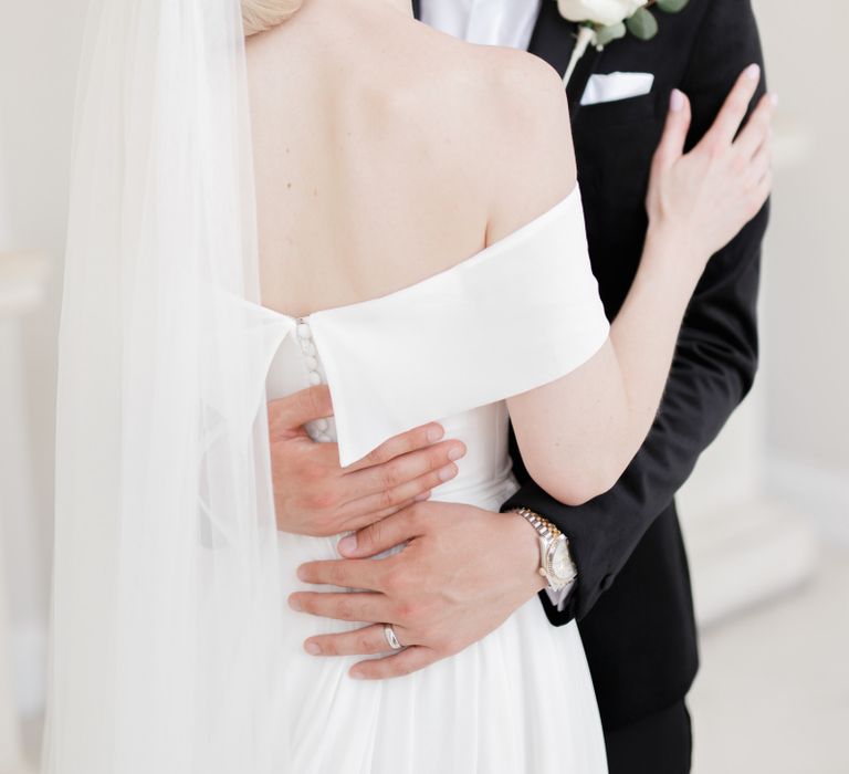 Bride with off the shoulder wedding dress and chic chignon