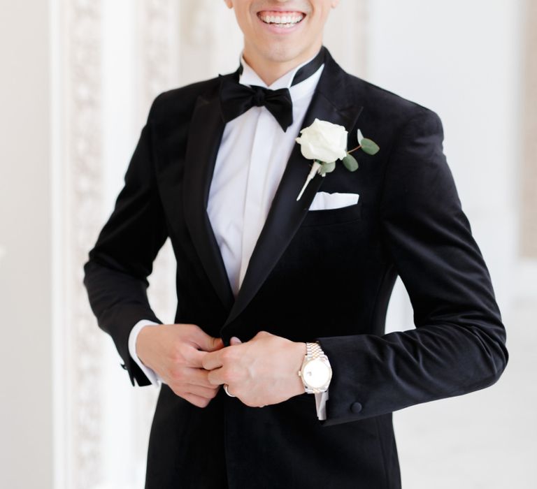 Groom in black tie suit and bow tie