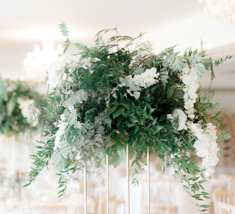 Tall white flower and greenery wedding centrepiece