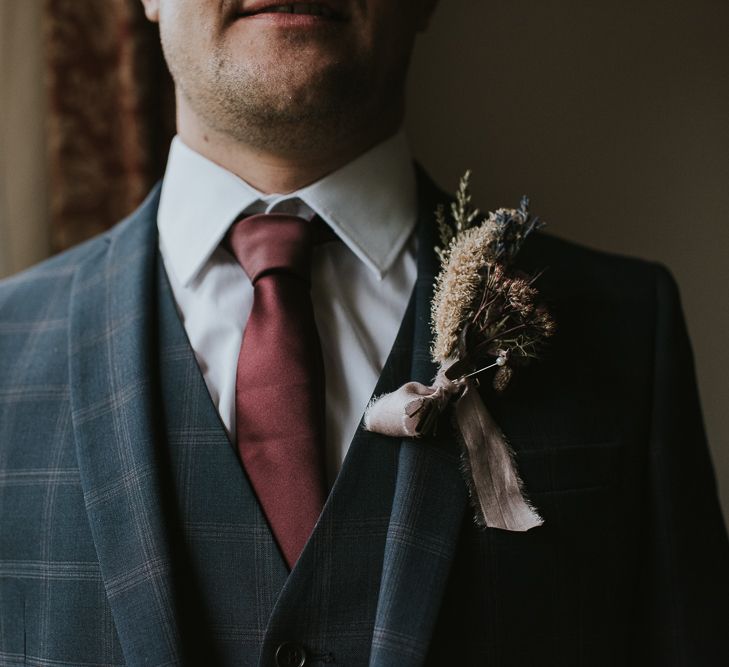 Groom in Check House of Fraser Suit with Burgundy  Tie and Dried Flower Buttonhole