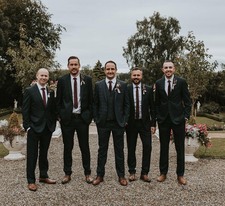 Groom in Check House of Fraser Suit and Groomsmen in Black Suits with Burgundy Ties