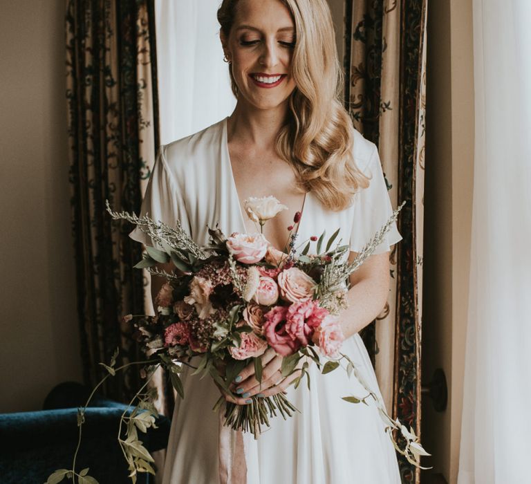 Bride in Houghton NYC Tiered Wedding Dress with Blush Pink and Raspberry Bridal Bouquet