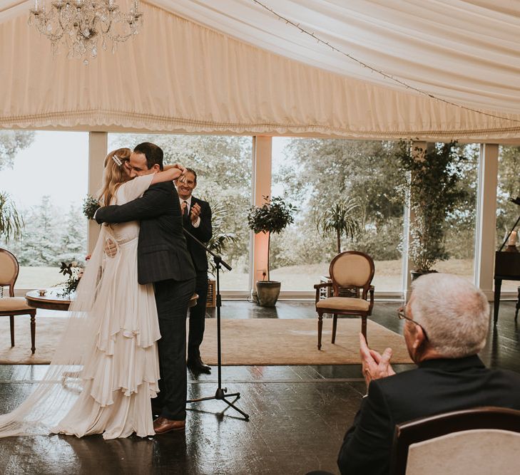 Wedding Ceremony with Bride in Houghton NYC Wedding Dress and Groom in Checked House of Fraser  Suit Hugging