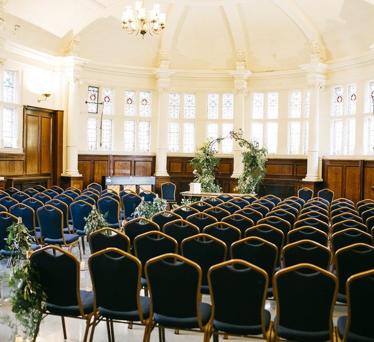 London ceremony with green and white foliage decor