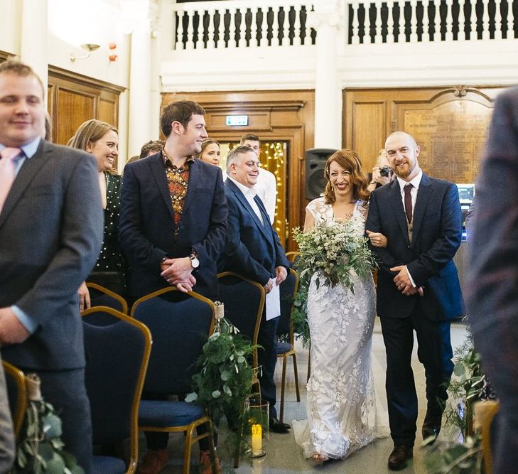 Bride wearing Phase Eight Wedding Dress walking down the aisle at London ceremony