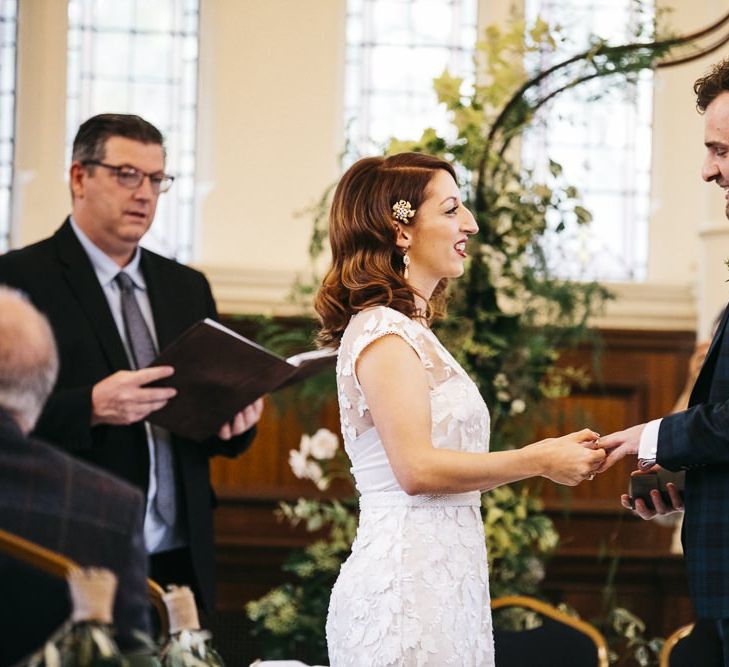 Bride wearing Phase Eight Wedding Dress at  London ceremony with foliage decor