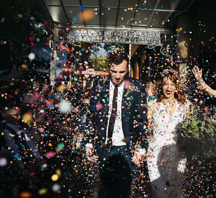 Bride and groom confetti shot at autumn celebration in London