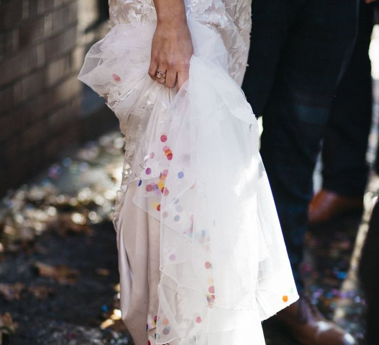 Bride wearing Phase Eight Wedding Dress and multi-coloured confetti