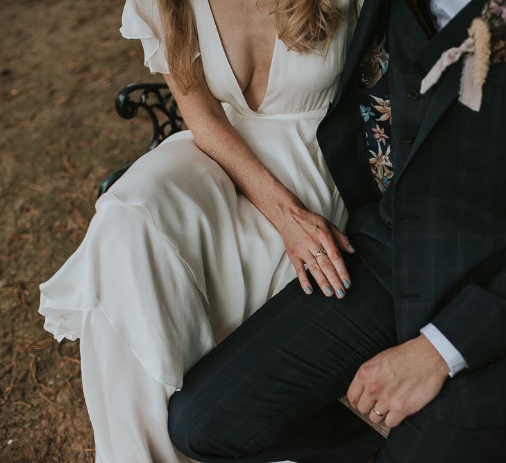 Bride in Tiered Houghton NYC Wedding Dress Resting Her Hands on Her Grooms Leg