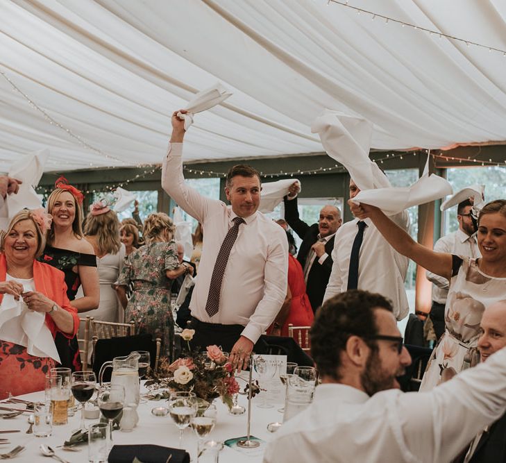 Wedding Guests Waving Their Napkins During the Wedding Reception