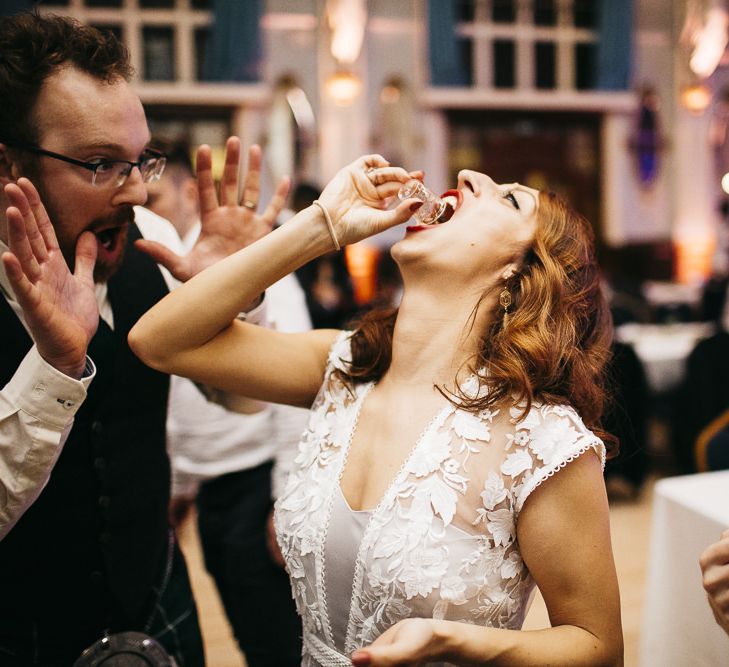 Bride having a vodka jelly shot with guests at London celebration