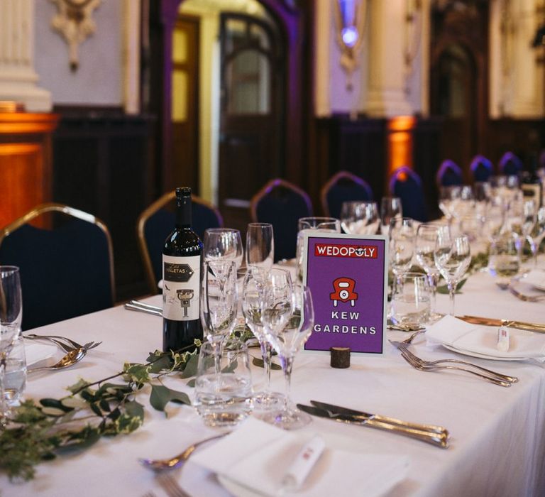 Monopoly style table plan settings with foliage decor at autumnal reception