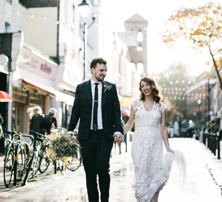 Bride and groom steal a moment wearing Phase Eight Wedding Dress