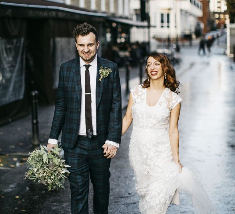 Bride and groom steal a moment wearing Phase Eight Wedding Dress