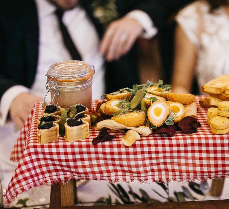 Food at reception with red gingham styling