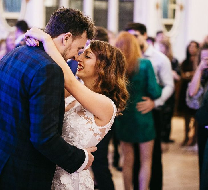 Bride and groom dance with their friends and family