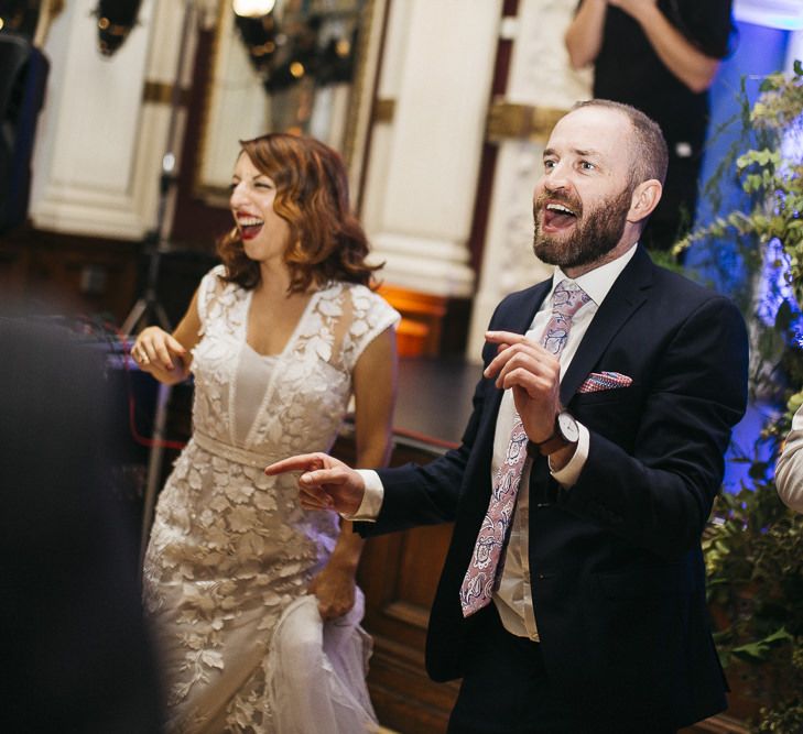 Bride and groom dance with their friends and family