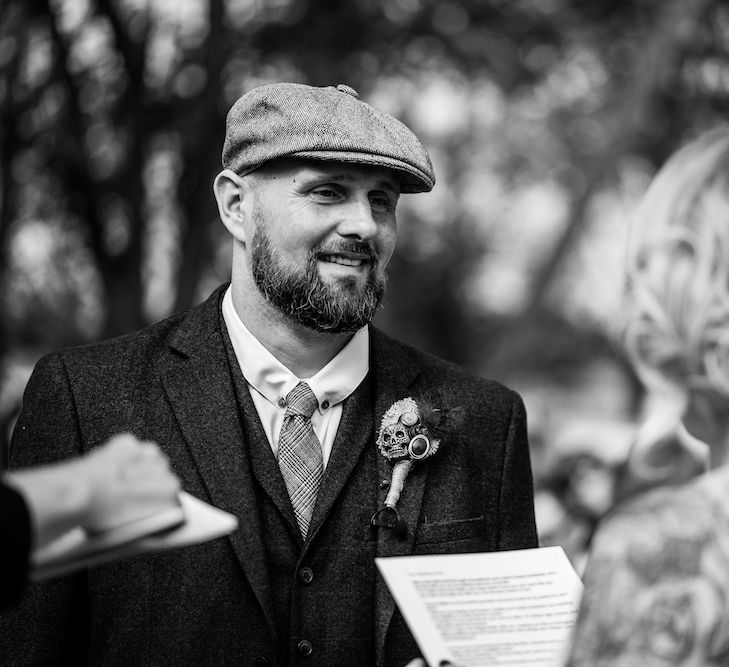 Wedding Ceremony | Bride in Strapless Sassi Holford Wedding Dress with Sweetheart Neckline | Groom in Burgundy Tweed Three Piece Suit | Edison Bulb Floral Installation at Kingsthorpe Lodge Barn Wedding | Johnny Dent Photography