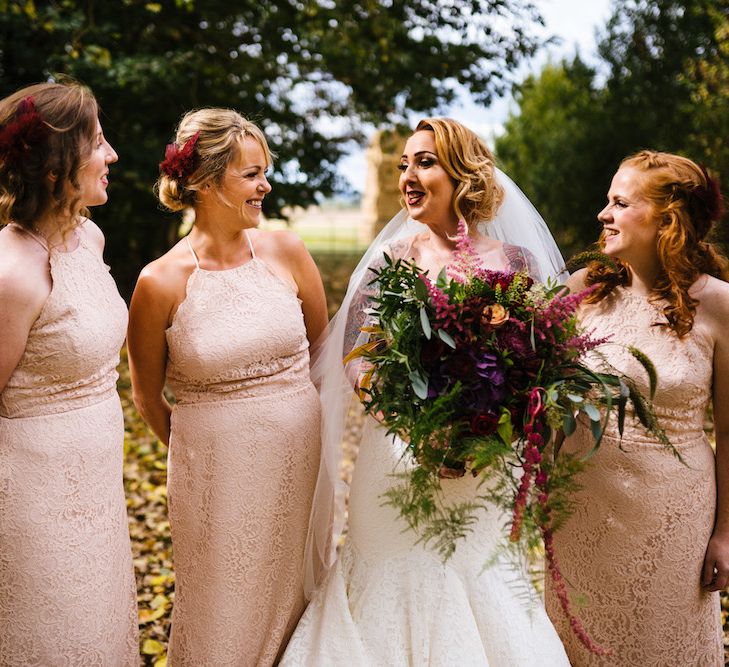 Bride in Strapless Sassi Holford Wedding Dress with Sweetheart Neckline | Bridesmaids in Pink Dessy Dresses | Edison Bulb Floral Installation at Kingsthorpe Lodge Barn Wedding | Johnny Dent Photography