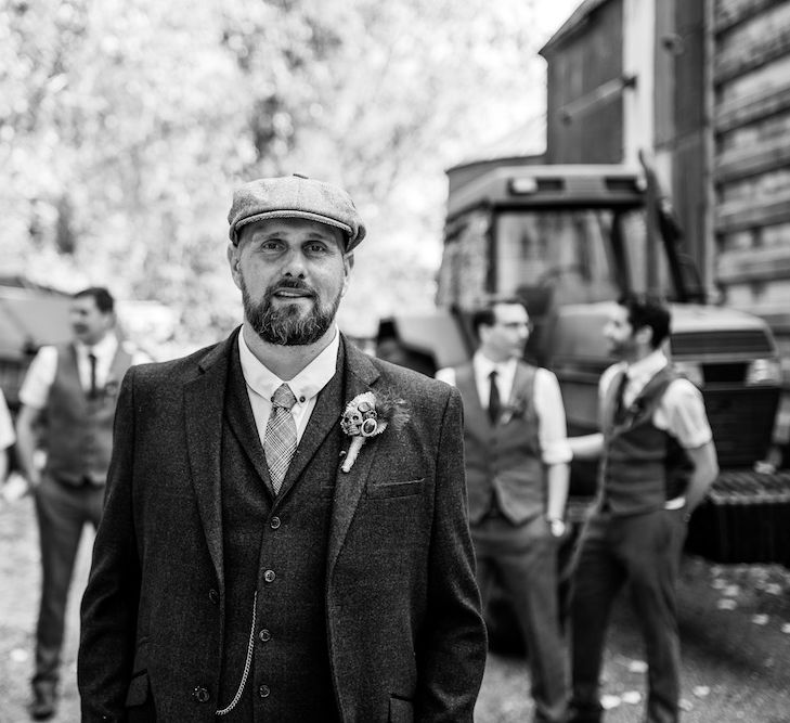 Groom in Burgundy Tweed Three Piece Suit | Groomsmen in Moss Bros. Baker Boy Suits | Edison Bulb Floral Installation at Kingsthorpe Lodge Barn Wedding | Johnny Dent Photography