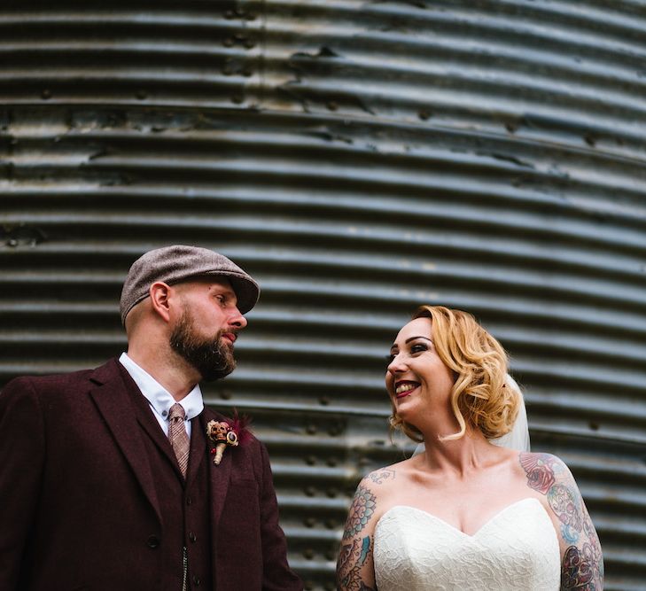 Bride in Strapless Sassi Holford Wedding Dress with Sweetheart Neckline | Groom in Burgundy Tweed Three Piece Suit | Edison Bulb Floral Installation at Kingsthorpe Lodge Barn Wedding | Johnny Dent Photography