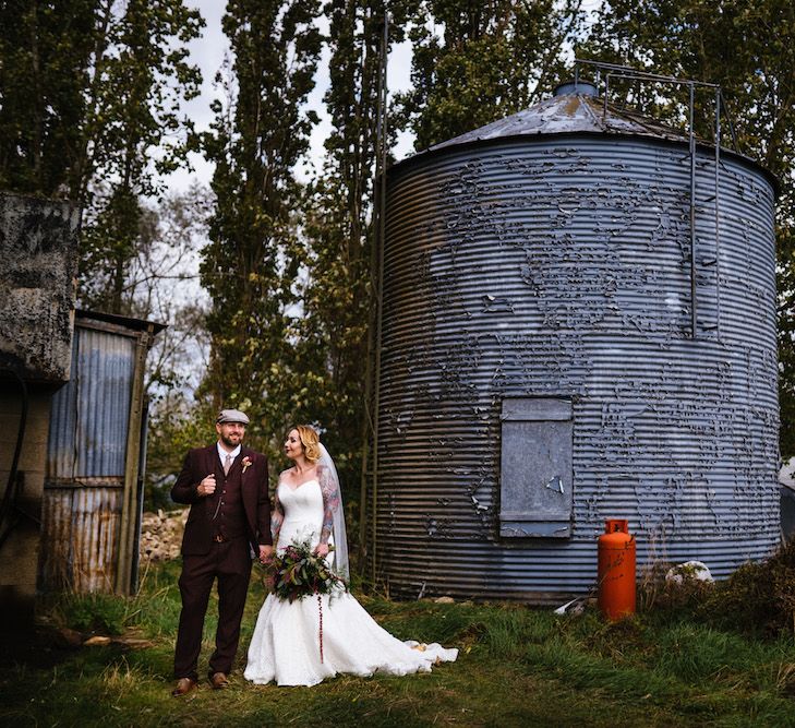 Bride in Strapless Sassi Holford Wedding Dress with Sweetheart Neckline | Groom in Burgundy Tweed Three Piece Suit | Edison Bulb Floral Installation at Kingsthorpe Lodge Barn Wedding | Johnny Dent Photography