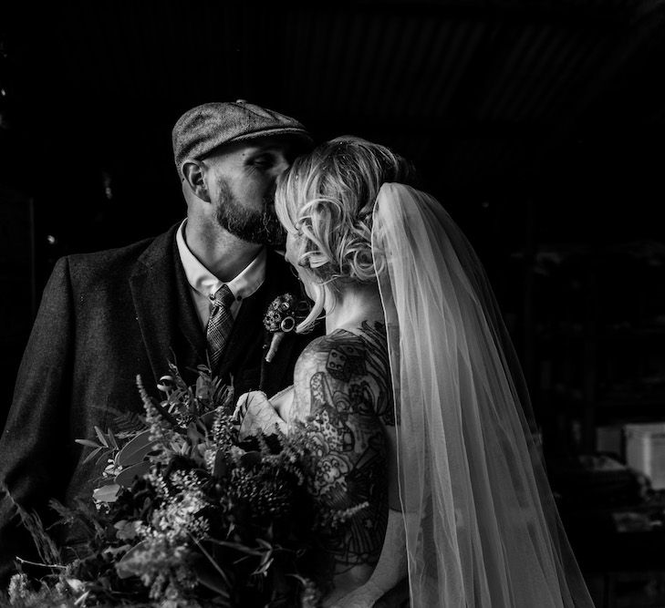 Bride in Strapless Sassi Holford Wedding Dress with Sweetheart Neckline | Groom in Burgundy Tweed Three Piece Suit | Edison Bulb Floral Installation at Kingsthorpe Lodge Barn Wedding | Johnny Dent Photography