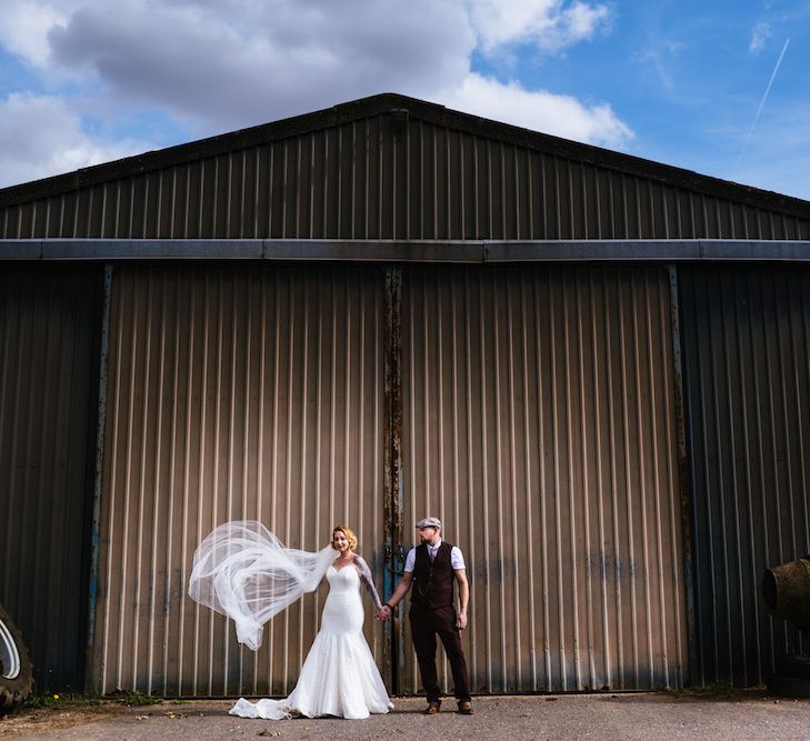 Bride in Strapless Sassi Holford Wedding Dress with Sweetheart Neckline | Groom in Burgundy Tweed Three Piece Suit | Edison Bulb Floral Installation at Kingsthorpe Lodge Barn Wedding | Johnny Dent Photography