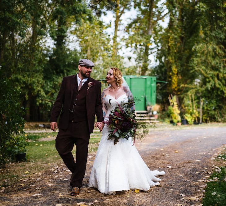 Bride in Strapless Sassi Holford Wedding Dress with Sweetheart Neckline | Groom in Burgundy Tweed Three Piece Suit | Edison Bulb Floral Installation at Kingsthorpe Lodge Barn Wedding | Johnny Dent Photography