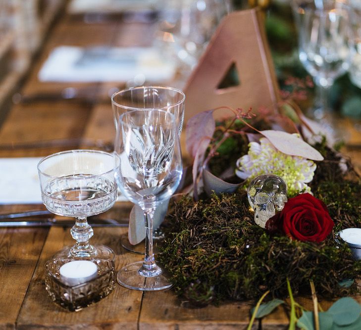 Wedding Reception Decor | Banquet Tables | Moss Garlands | Glass Skulls | Edison Bulb Floral Installation at Kingsthorpe Lodge Barn Wedding | Johnny Dent Photography