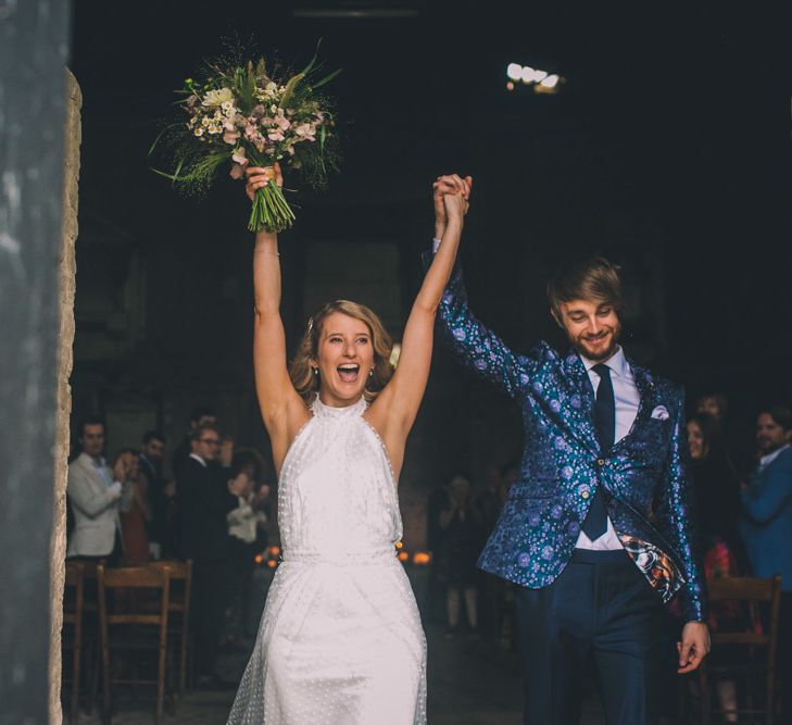 Bride and Groom Celebrate Coming Out Of Venue