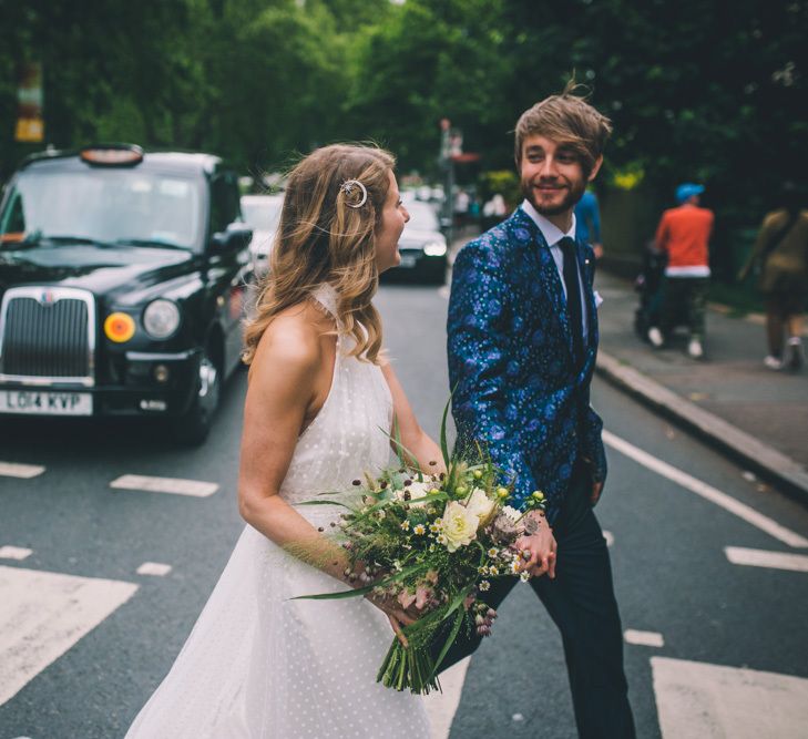 Groom Wears Patterned Suit and Bride Wears Bridal Trainers