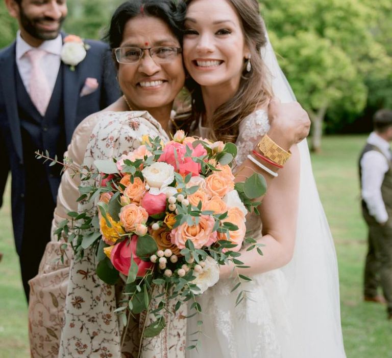 Bride greets wedding guests with bright bouquet