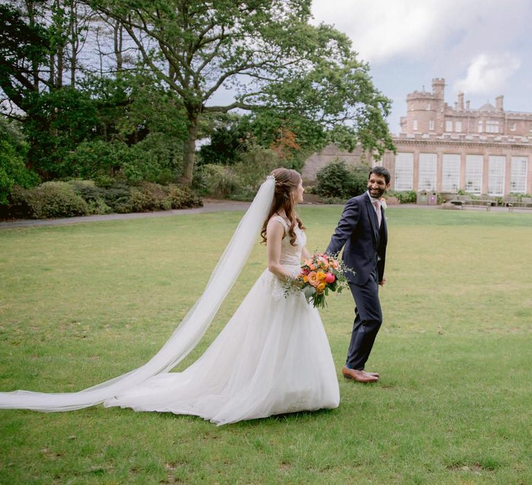 Bride in princess dress and long veil with  groom at Culzean Castle wedding in Scotland