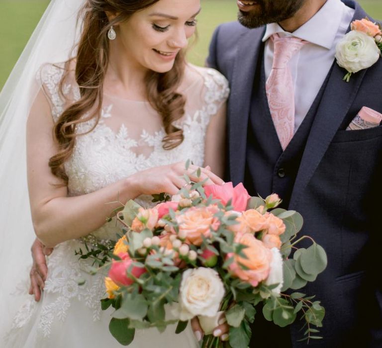 Bright coral and pink wedding bouquet and matching buttonhole