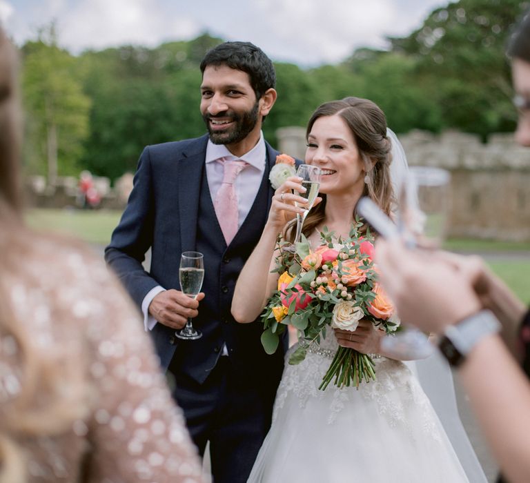 Bride and groom enjoy drinks outside at Culzean Castle wedding in Scotland