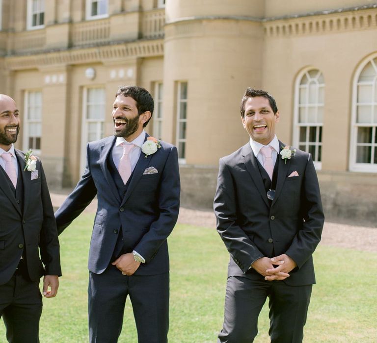 Groomsmen in matching suits with pink ties