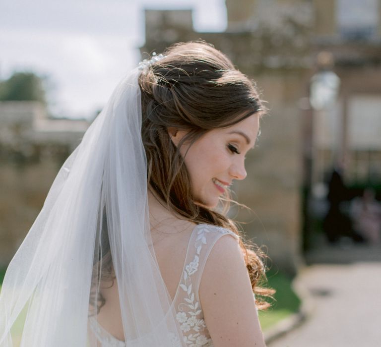 Lace detail wedding dress with veil and half up half down hair do