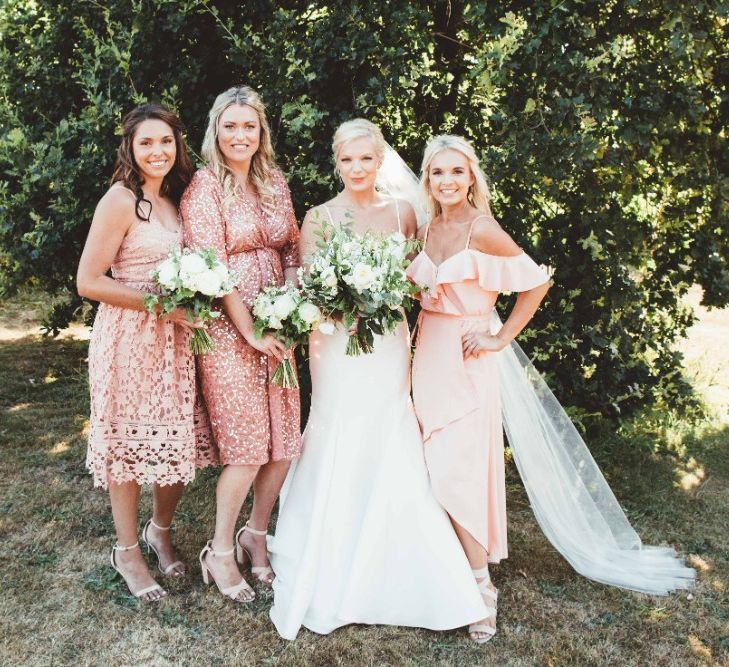 Bride in Essense of Australia Dress with Spaghetti Straps and Fishtail | Floor Length Veil | Bridesmaids in Mismatched Pink Dresses | Bouquets of White Flowers and Greenery | Quintessential English Country Wedding in Glass Marquee at Family Home | Maryanne Weddings Photography