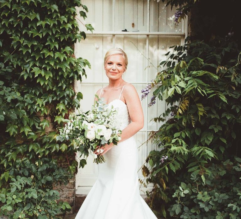 Bride in Essense of Australia Dress with Spaghetti Straps and Fishtail | Bridal Bouquet of White Flowers and Greenery | Quintessential English Country Wedding in Glass Marquee at Family Home | Maryanne Weddings Photography