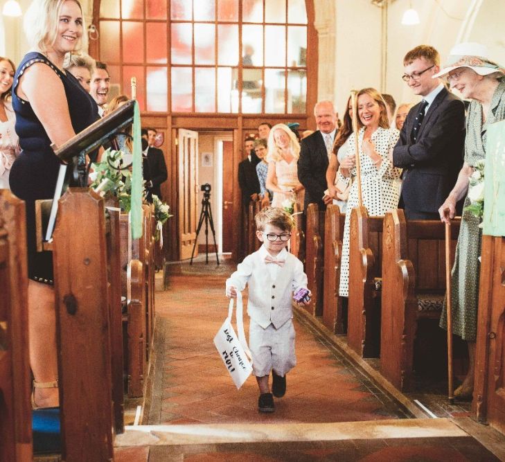 Wedding Ceremony | Page Boy in Grey Waistcoat and Pink Bow Tie | Quintessential English Country Wedding in Glass Marquee at Family Home | Maryanne Weddings Photography