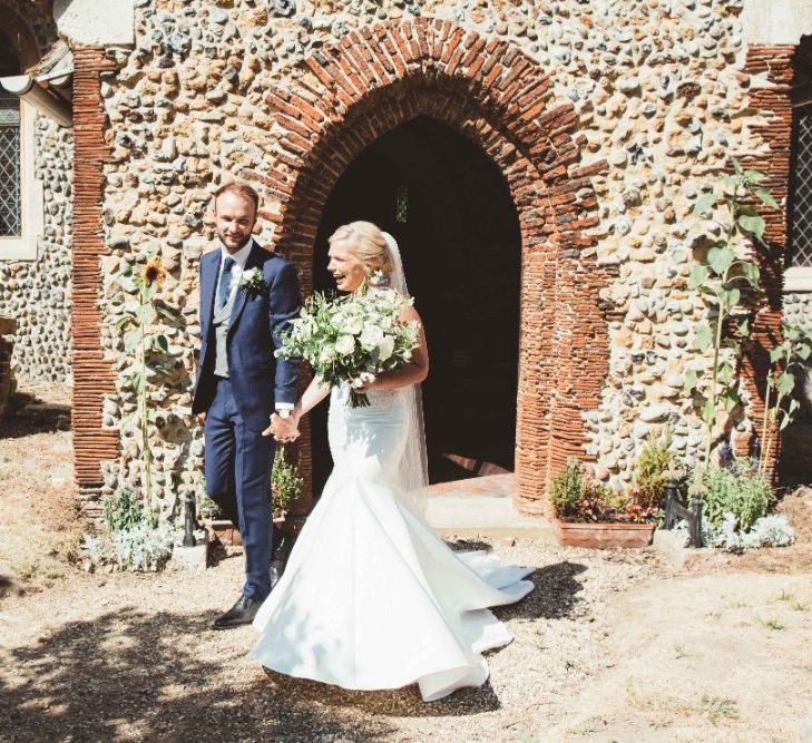 Just Married | Bride in Essense of Australia Dress with Spaghetti Straps and Fishtail | Floor Length Veil | Bridal Bouquet of White Flowers and Greenery | Groom in Blue Suit with White and Green Buttonhole | Quintessential English Country Wedding in Glass Marquee at Family Home | Maryanne Weddings Photography