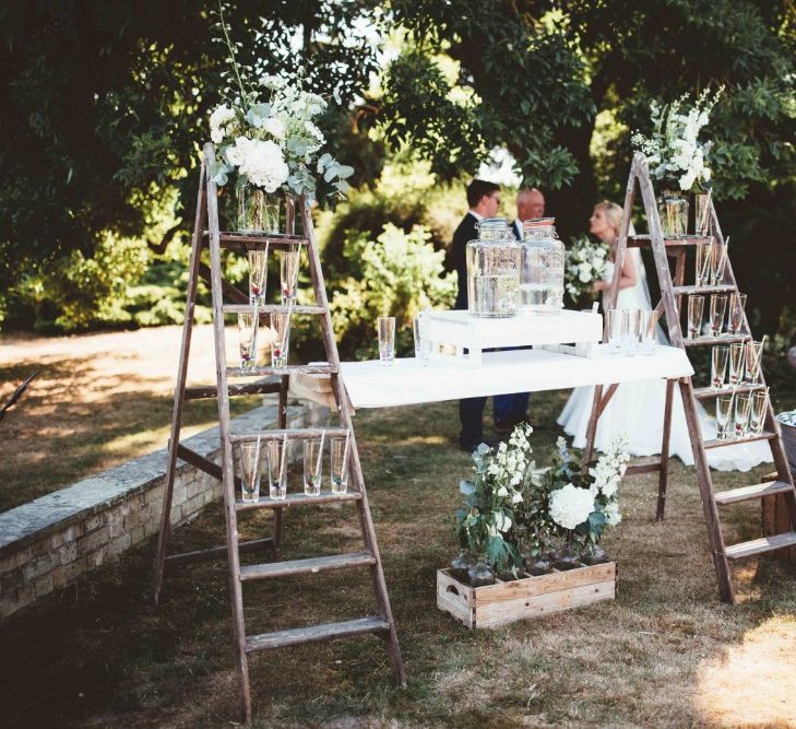 Drinks Station with Rustic Ladders | Kilner Jars | Beer Troughs | White Flowers and Greenery | Quintessential English Country Wedding in Glass Marquee at Family Home | Maryanne Weddings Photography