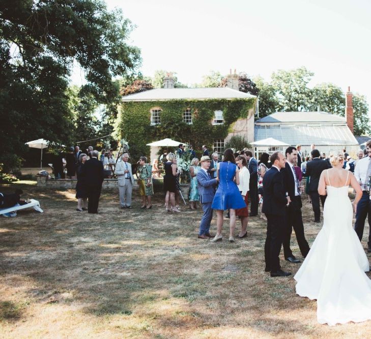 Wedding Reception | Drinks in the Garden | Bride in Essense of Australia Dress with Spaghetti Straps and Fishtail | Quintessential English Country Wedding in Glass Marquee at Family Home | Maryanne Weddings Photography