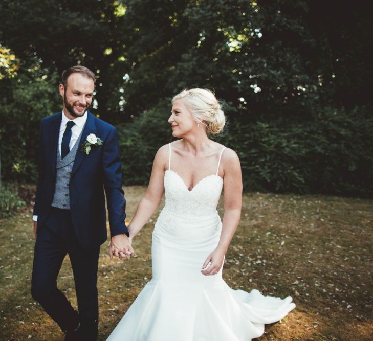 Bride in Essense of Australia Dress with Spaghetti Straps and Fishtail | Groom in Blue Suit with White and Green Buttonhole | Quintessential English Country Wedding in Glass Marquee at Family Home | Maryanne Weddings Photography