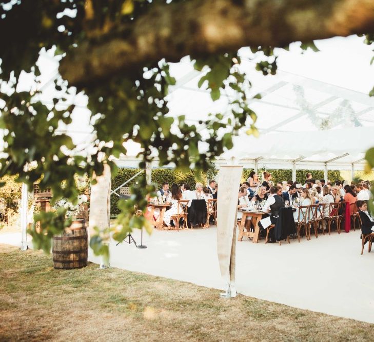 Wedding Reception | Glass Marquee | Long Wooden Farmhouse Tables | Quintessential English Country Wedding in Glass Marquee at Family Home | Maryanne Weddings Photography