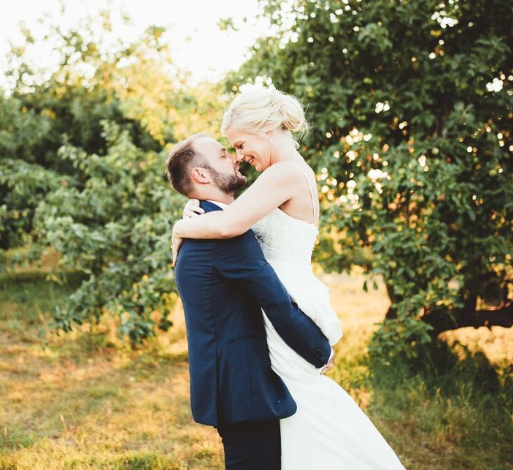 Bride in Essense of Australia Dress with Spaghetti Straps and Fishtail | Groom in Blue Suit with White and Green Buttonhole | Quintessential English Country Wedding in Glass Marquee at Family Home | Maryanne Weddings Photography