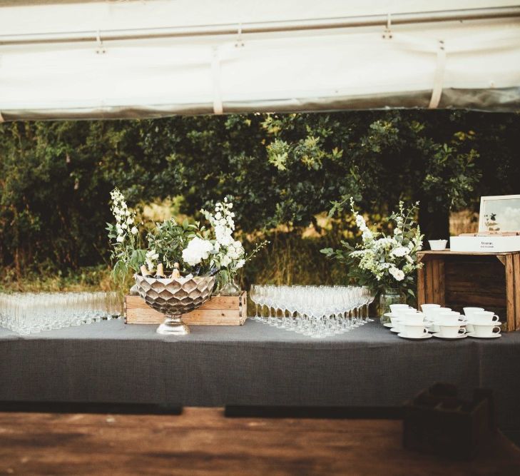 Wedding Reception Drinks Table | Wooden Crates | Large Floral Displays | Quintessential English Country Wedding in Glass Marquee at Family Home | Maryanne Weddings Photography