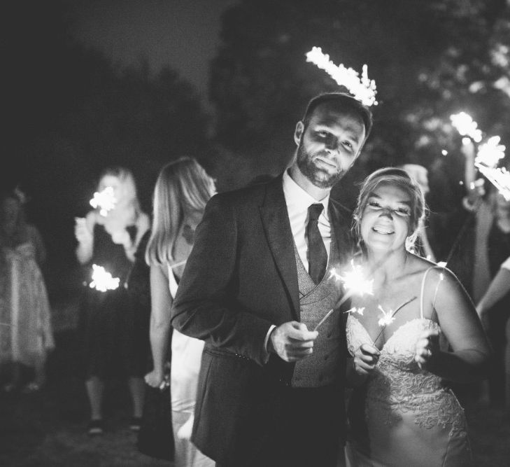 Sparklers | Bride in Essense of Australia Dress with Spaghetti Straps and Fishtail | Groom in Blue Suit with Grey Waistcoat | Quintessential English Country Wedding in Glass Marquee at Family Home | Maryanne Weddings Photography